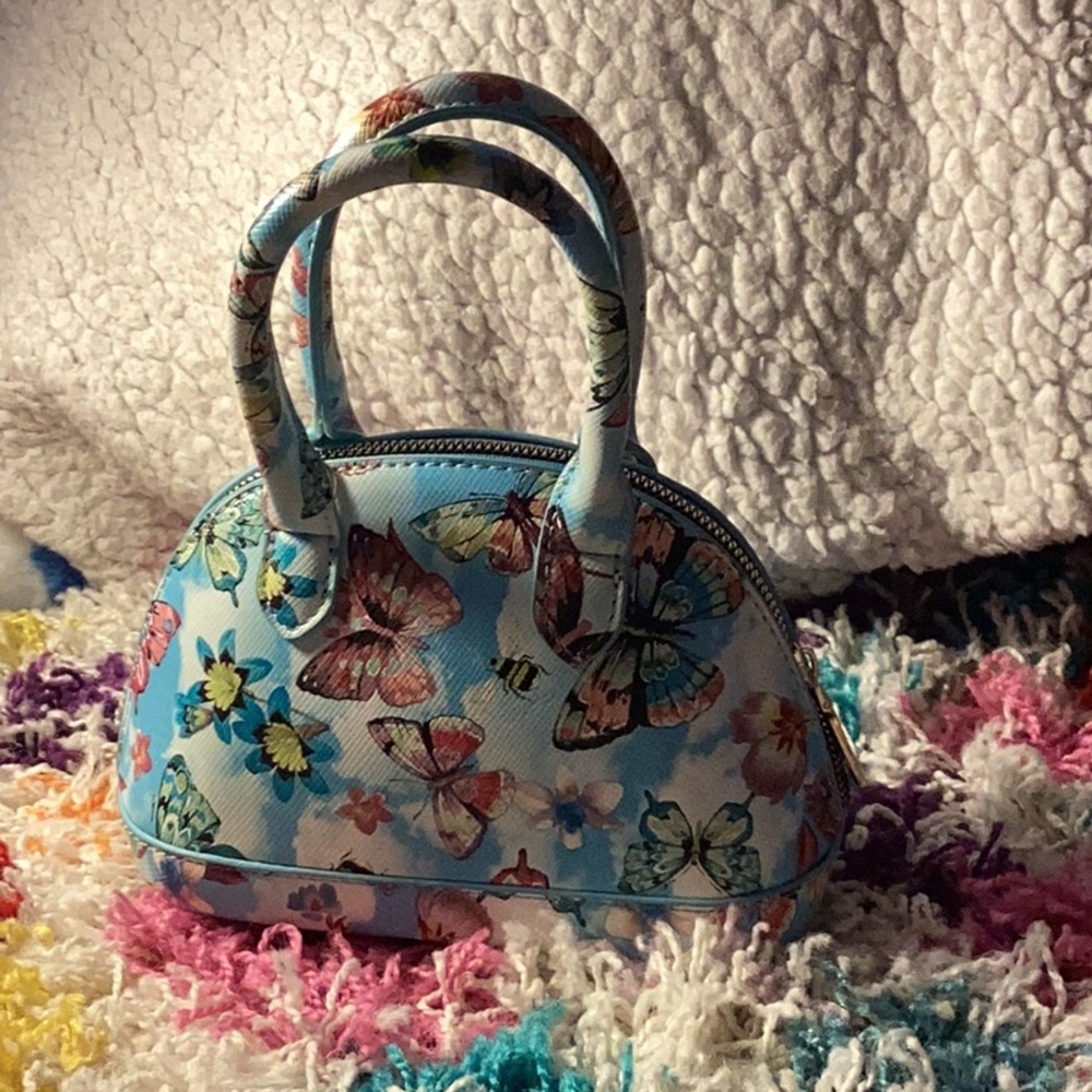 Blue butterfly purse with comfortable handle and golden zipper